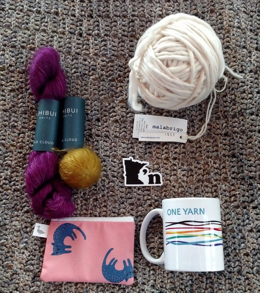 photo of yarn, notions bag, sticker and mug